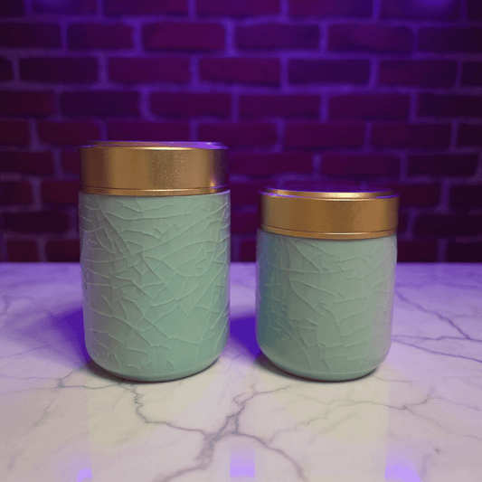Celadon Porcelain Stash Jar – Light Green Ceramic Herb Storage ContainerTwo light green celadon porcelain jars with gold lids on a marble surface