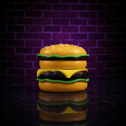 Cheese Burger Herb Grinder. Cheeseburger shaped grinder container with a reflective surface against a brick wall background