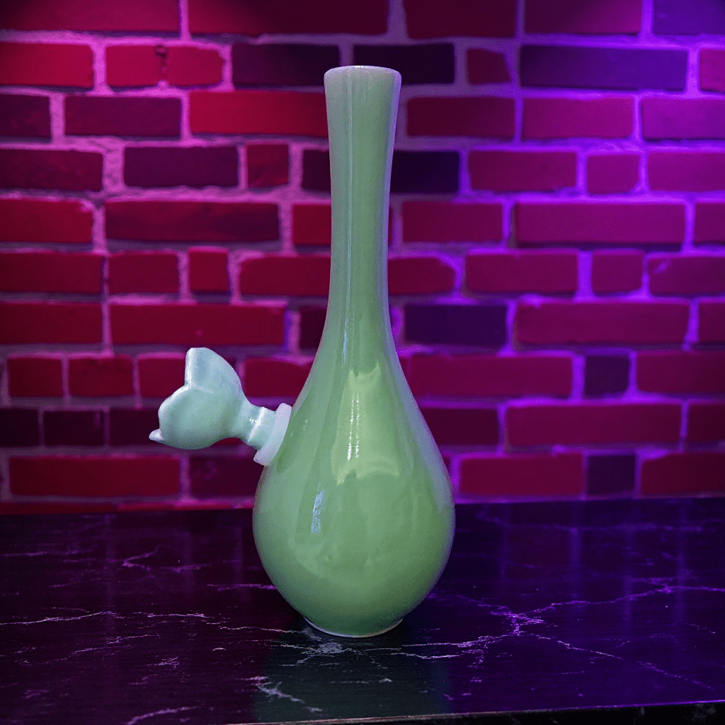 Classic Green Celadon Porcelain Bong with Slim Neck Designslim neck classic green celadon porcelain bong with ceramic bowl is placed on a marble surface.