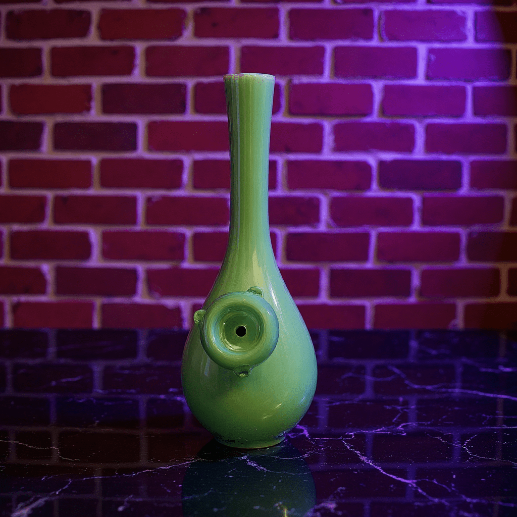 Classic Green Celadon Porcelain Bong with Slim Neck DesignGreen ceramic bong with glass bowl on a reflective surface with a brick wall background