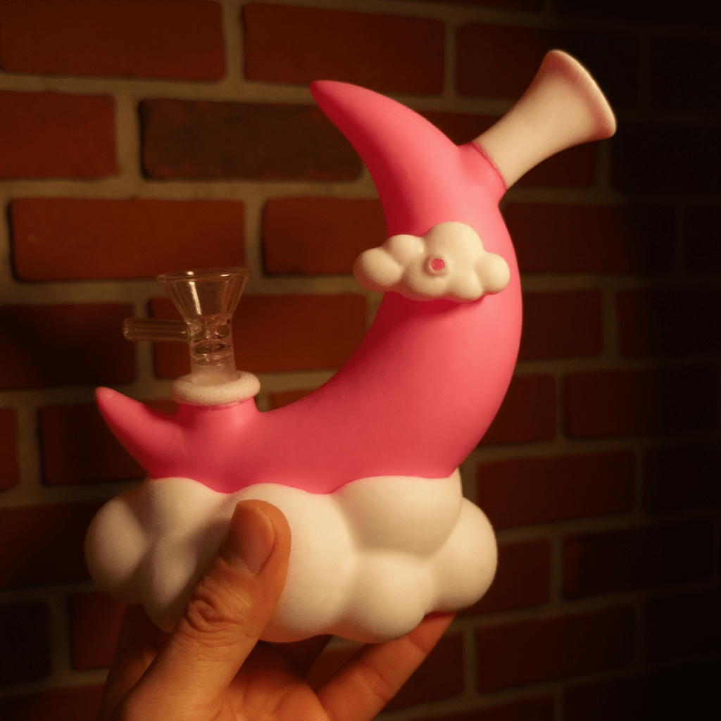 ☁️ CloudBreaker Water Pipe - Dreamy Silicone BongPink and white silicone bong held by a hand resembling a moon with a cloud and bowl