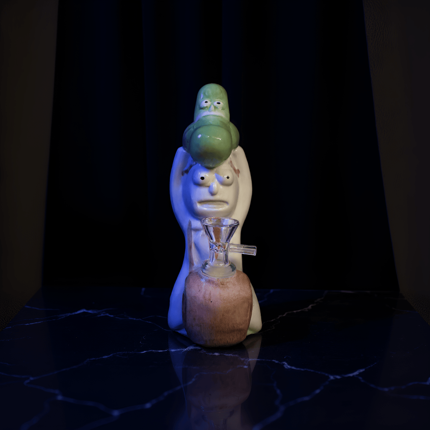 Cosmic Sidekick Ceramic Water Pipe Cartoon pickle ceramic bong on a wooden table in a cozy bedroom.