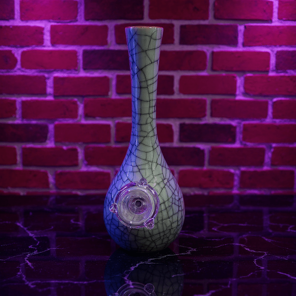 Crackle Glaze Slim Neck Celadon Porcelain Bonga slim neck crackle celadon porcelain bong with glass bowl is placed on a surface.