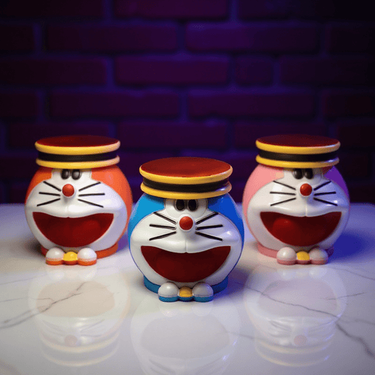 Cute Cat Crank GrinderThree cartoon character weed grinders with colorful designs on a reflective surface.