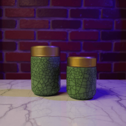 Deep Green Celadon Porcelain Stash Jar – Large & Small SizesTwo green celadon porcelain jars with gold lids on a marble surface