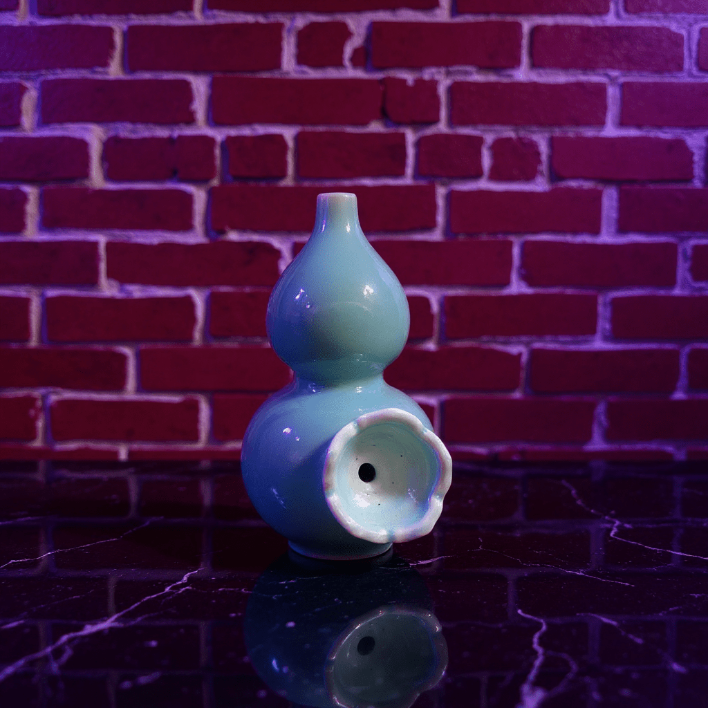 Glossy Blue Celadon Gourd Porcelain BongBlue ceramic gourd - shaped bong with a ceramic bowl on a reflective surface