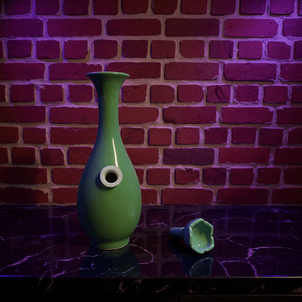 Glossy Green Celadon Bong with Flared TopFlared Neck Glossy Green Celadon Porcelain Bong and ceramic bowl are placed on a marble surface.