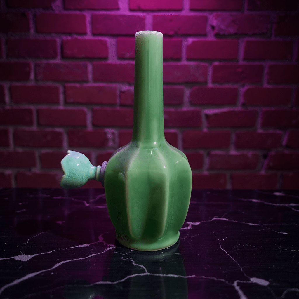 Glossy Green Flat - Sided Celadon Porcelain BongGlossy Green Flat - Sided Celadon Porcelain Bong with ceramic bowl is placed on a marble surface.