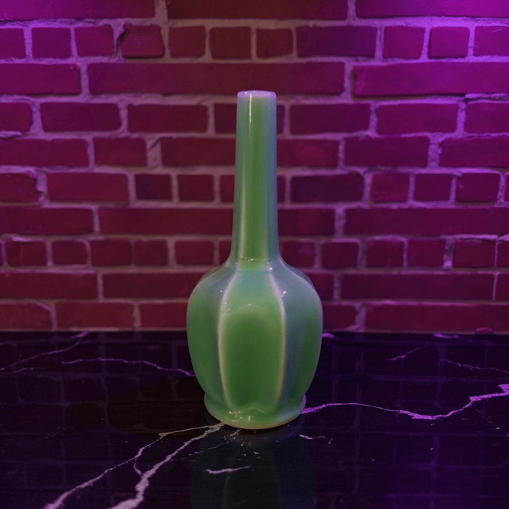 Glossy Green Flat - Sided Celadon Porcelain BongGreen bong on a reflective surface with a brick wall background