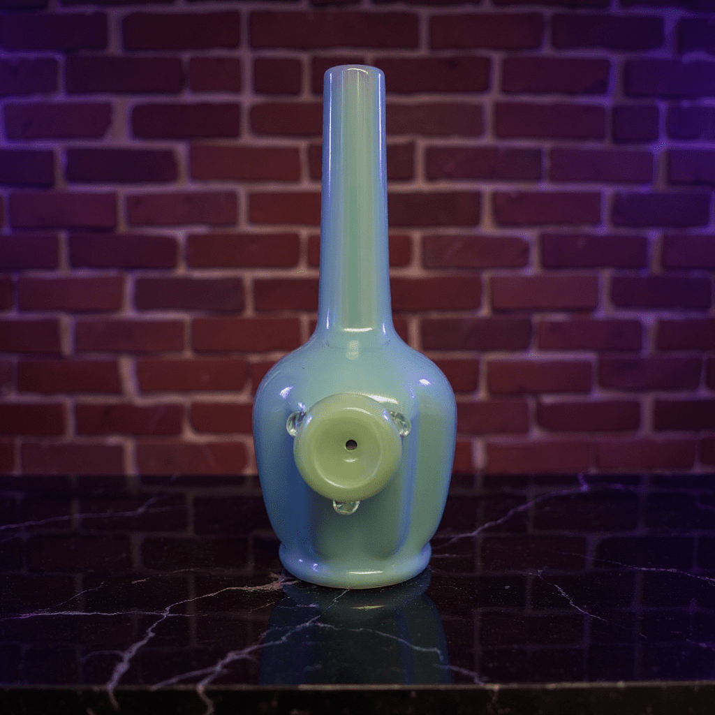 Glossy Light Blue Celadon Flat - Sided Porcelain BongGlossy Light Blue Celadon Flat - Sided Porcelain Bong with glass bowl is placed on a marble surface.