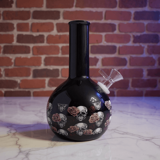 Gothic Skull Rose Ceramic Bong – Black ceramic bong with skull and floral design on a marble surface
