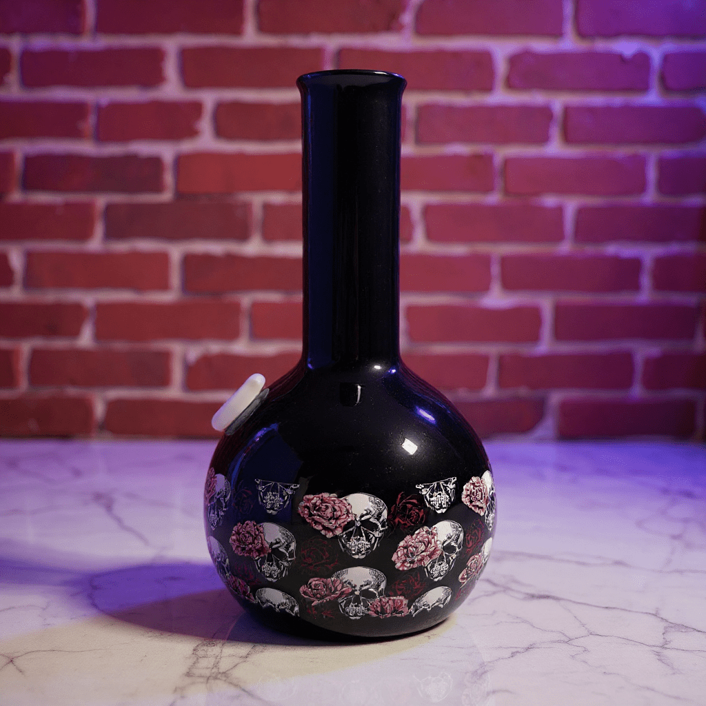 Gothic Skull Rose Ceramic Bong – Black bong with skull and rose pattern on a marble surface with brick wall background