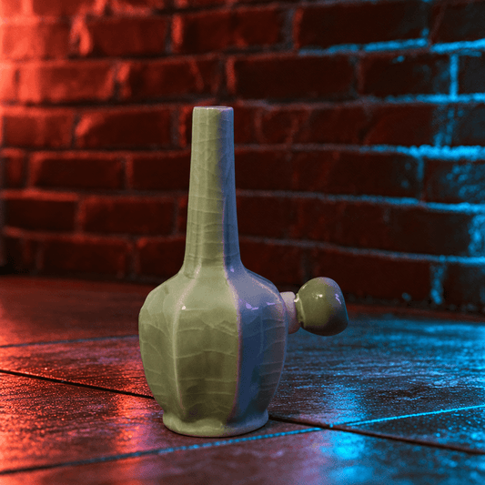 Green Dragon Scale Celadon Flat-Sided Porcelain BongIce - Crack Green Celadon Flat - Sided Porcelain Bong with glass bowl is placed on a wooden surface.
