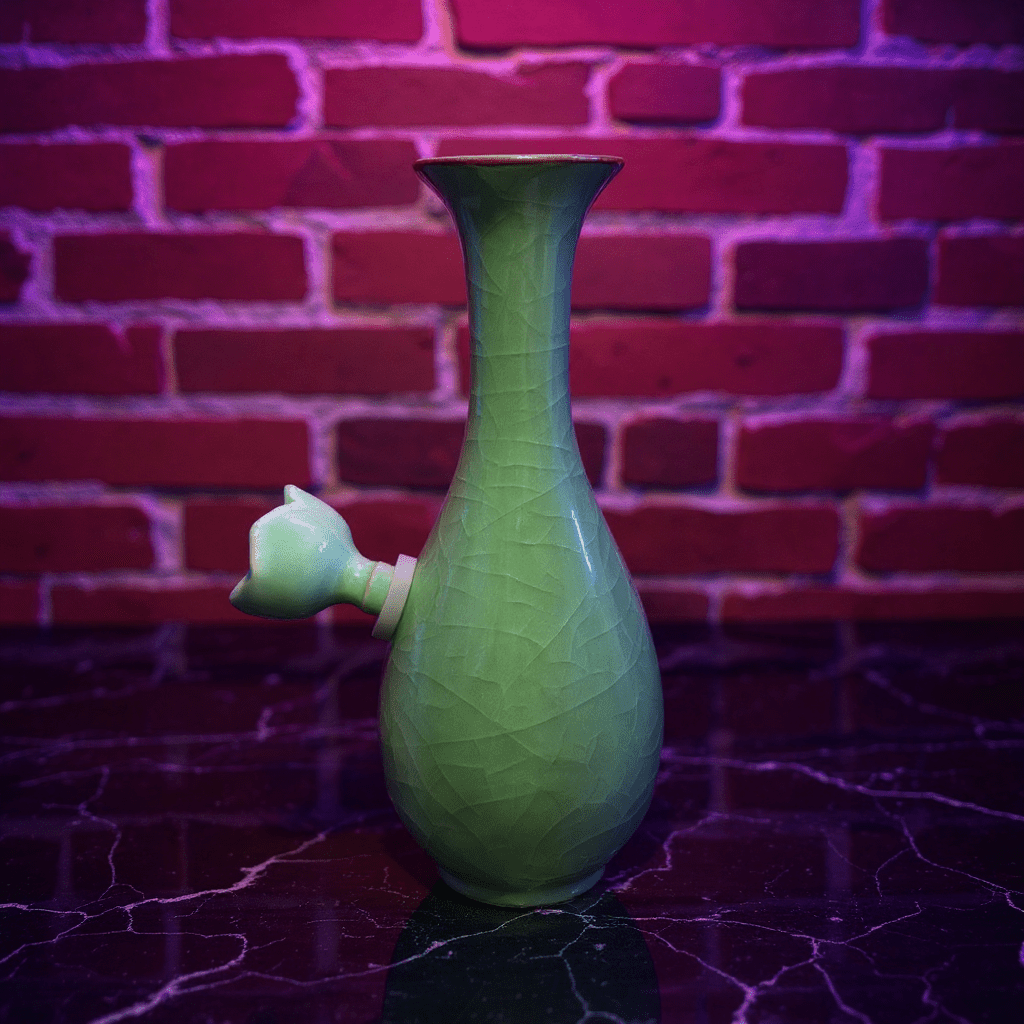 Green Ice - Crack Celadon Porcelain Bong with Flared TopGreen Ice - Crack Celadon Porcelain Bong with ceramic bowl is placed on a marble surface.