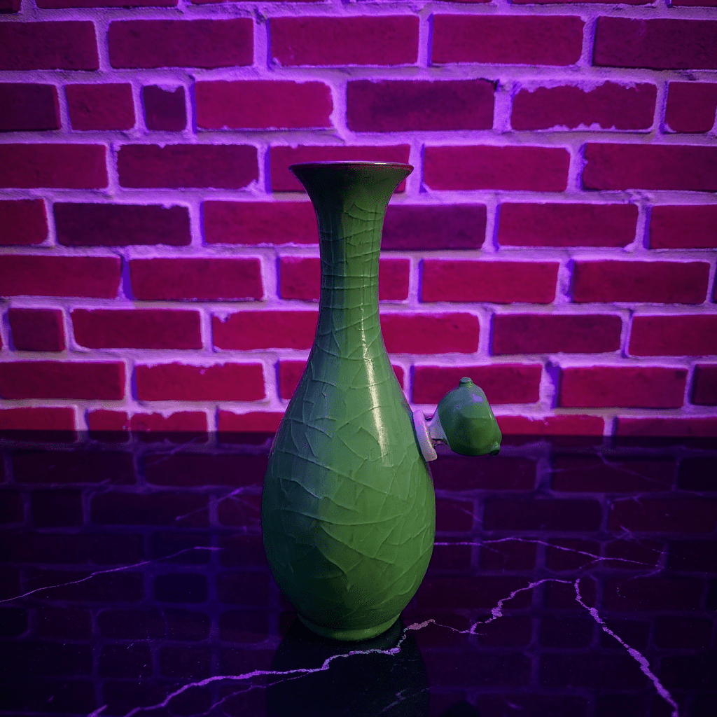 Green Ice - Crack Celadon Porcelain Bong with Flared TopGreen Ice - Crack Celadon Porcelain Bong with glass bowl is placed on a marble surface