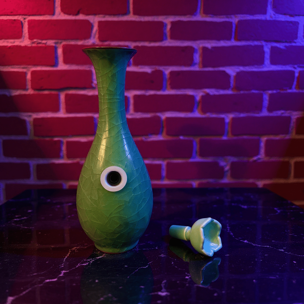 Green Ice - Crack Celadon Porcelain Bong with Flared TopGreen Ice - Crack Celadon Porcelain Bong and ceramic bowl are placed on a marble surface.