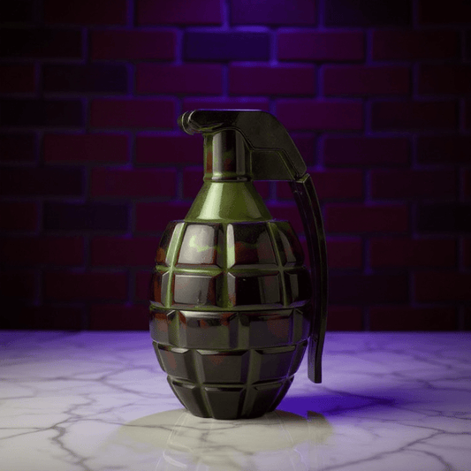 Grenade Herb Grinder – Camouflage DesignGrenade shape grinder on a reflective surface with a brick wall background
