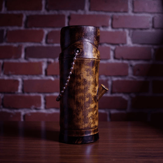 Handcrafted Bamboo Bong – Eco - Friendly Water Pipe with Natural Aromabamboo bong with decorative elements on a wooden surface