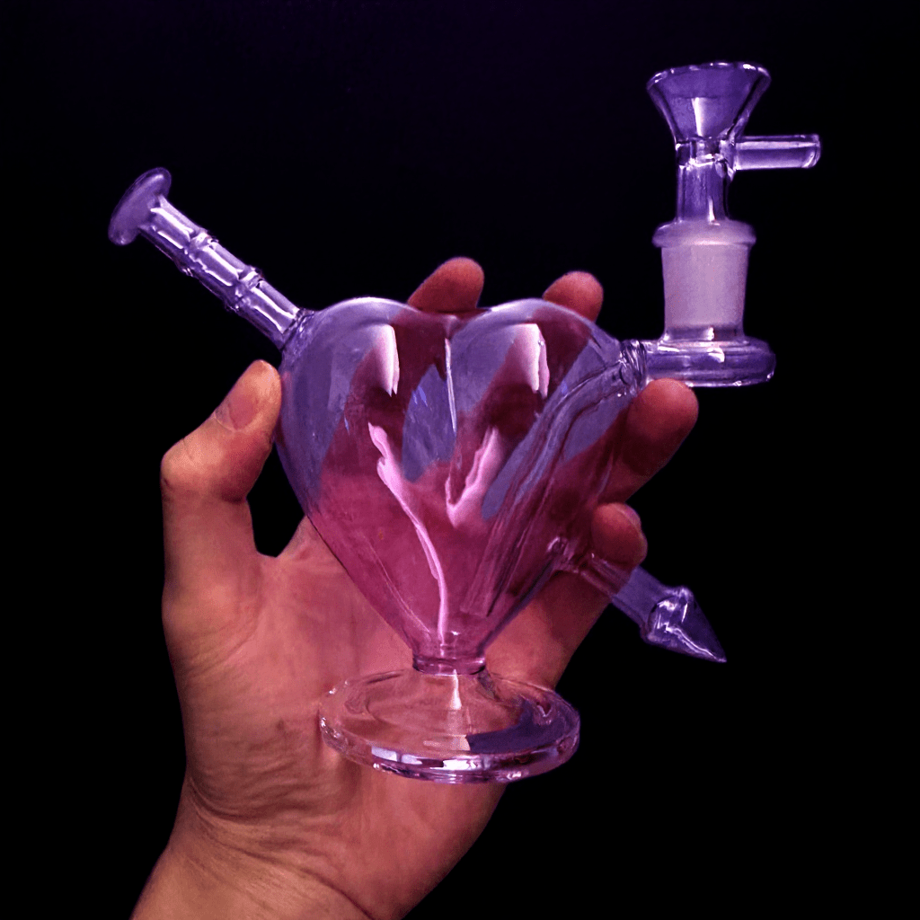 Heartpiercer glass bong - Purple VersionHand holding a purple glass bong against a black background