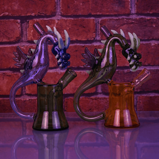 House of Dragon Glass Bong β RPG & Anime Style Water PipeTwo glass smoking accessories with dragon designs against a brick wall background.