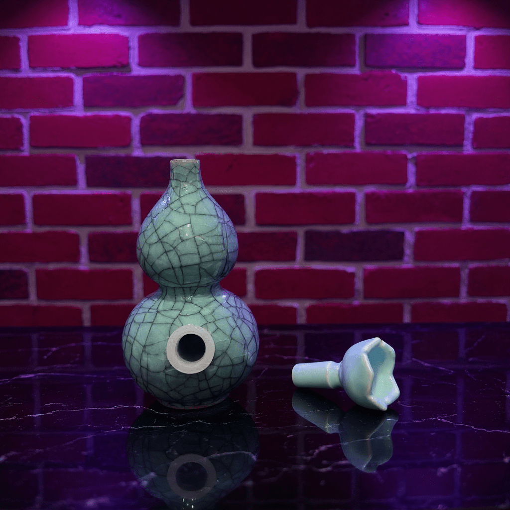 Ice - Crack Blue Celadon Gourd Porcelain BongIce - Crack Blue Celadon Gourd Porcelain Bong and ceramic bowl are placed on a marble surface.