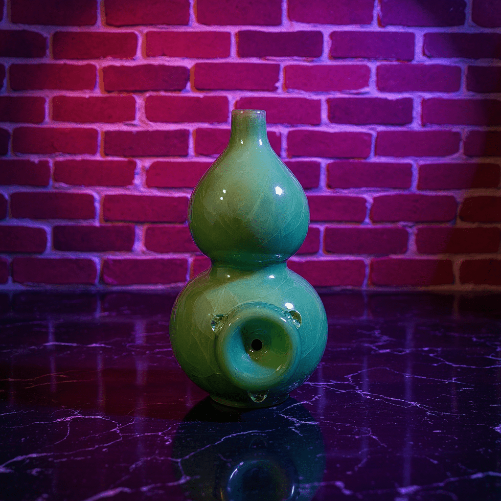 Ice - Crack Green Celadon Gourd Porcelain BongGreen porcelain smoking bong on a reflective surface with a brick wall background