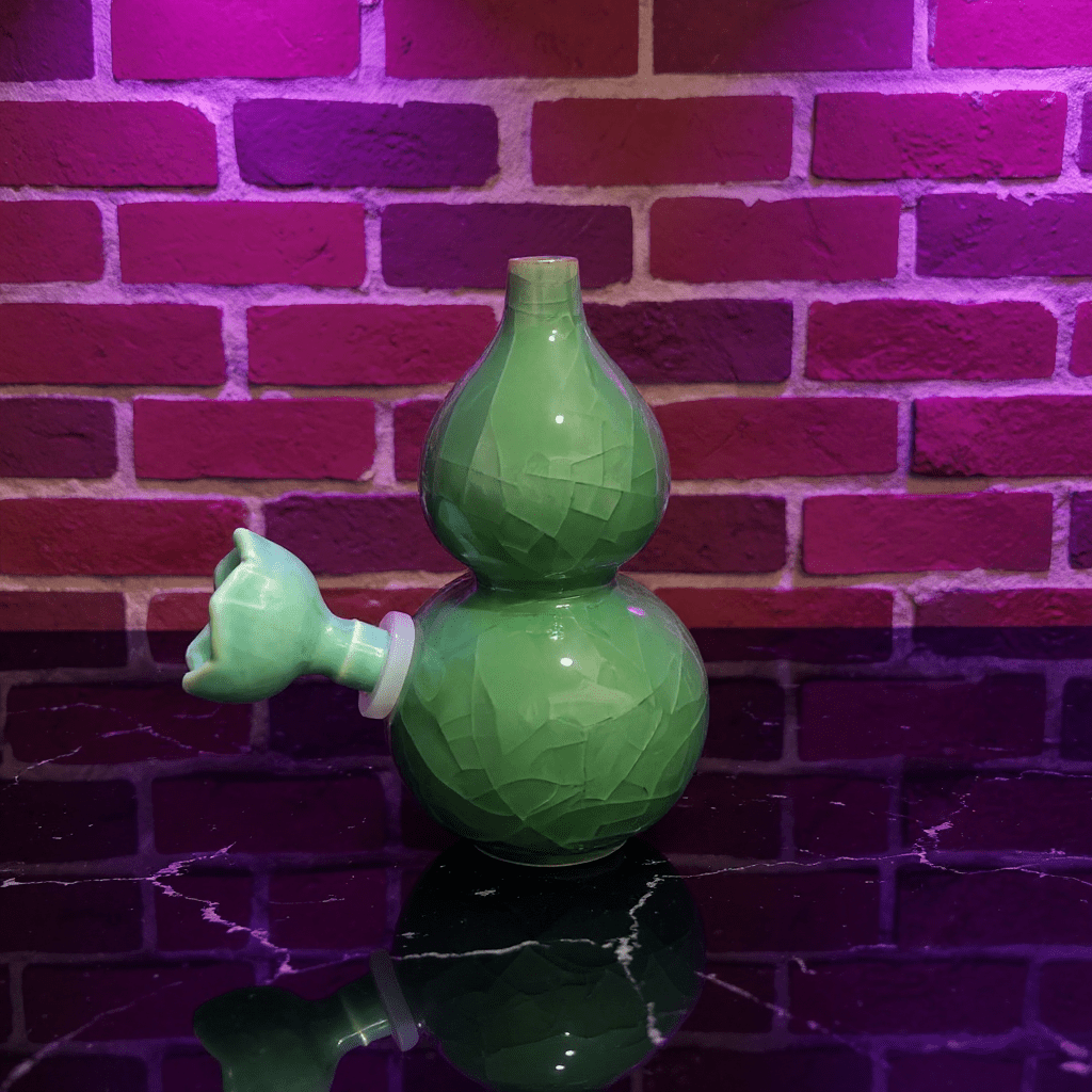 Ice - Crack Green Celadon Gourd Porcelain BongIce - Crack Green Celadon Gourd Porcelain Bong with ceramic bowl is placed on a marble surface.