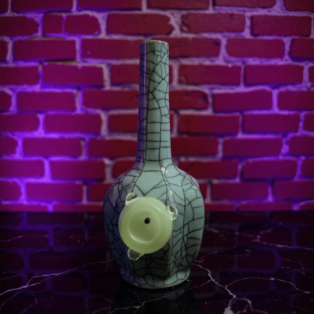 Ice - Crack Light Blue Celadon Flat - Sided Porcelain BongDecorative vase with cracked ceramic bong design against a brick wall
