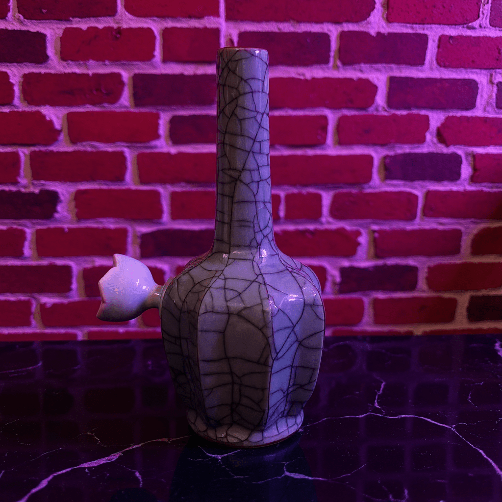 Ice - Crack Light Blue Celadon Flat - Sided Porcelain BongIce - Crack Light Blue Celadon Flat - Sided Porcelain Bong with ceramic bowl is placed on a marble surface.
