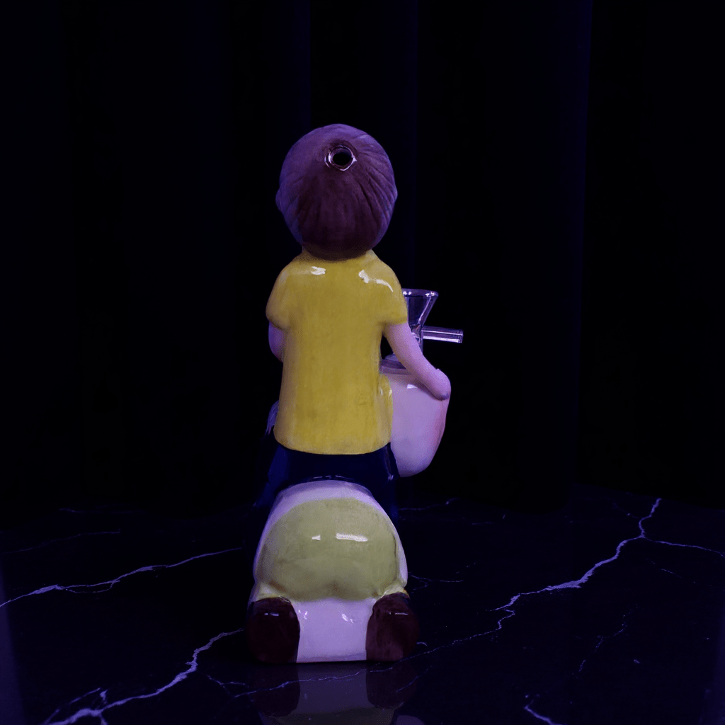 Morty Stack Ceramic Bong – Rear view of Rick and Morty cartoon bong in use with visible smoke in bedroom setting.