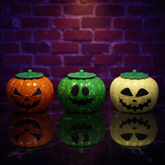 Pumpkin Herb Grinder – 3 - Piece GrinderThree Halloween - themed pumpkins herb grinder with smiling faces