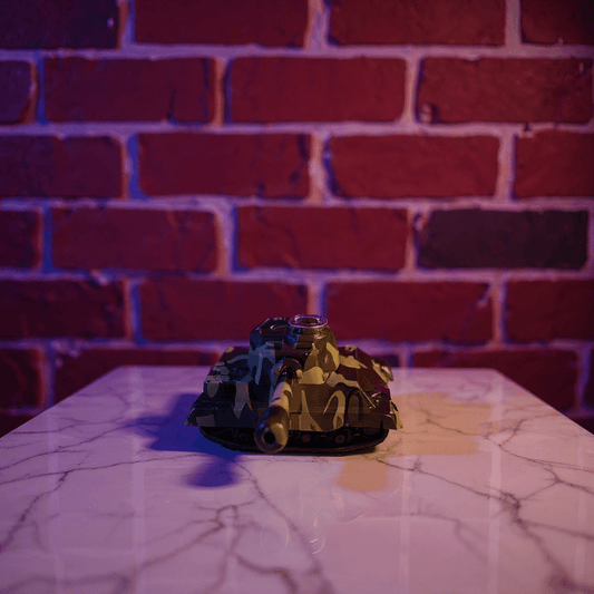 Toy tank grinder on a marble surface with a brick wall background