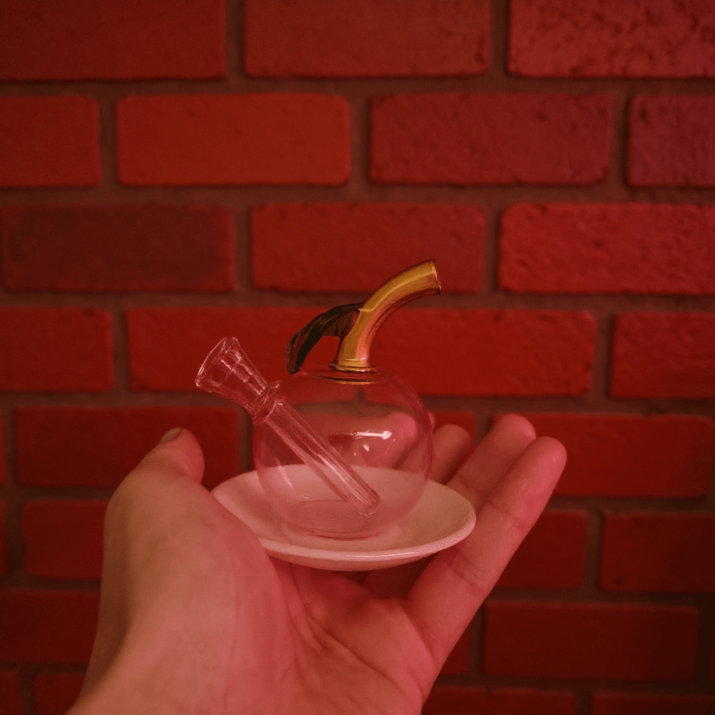🍎 Apple Glass Bong – Mini Fruit Water PipeHand holding a small glass bong - colored object