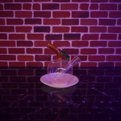🍎 Apple Glass Bong – Mini Fruit Water PipeGlass smoking bong with a metallic accent on a white plate