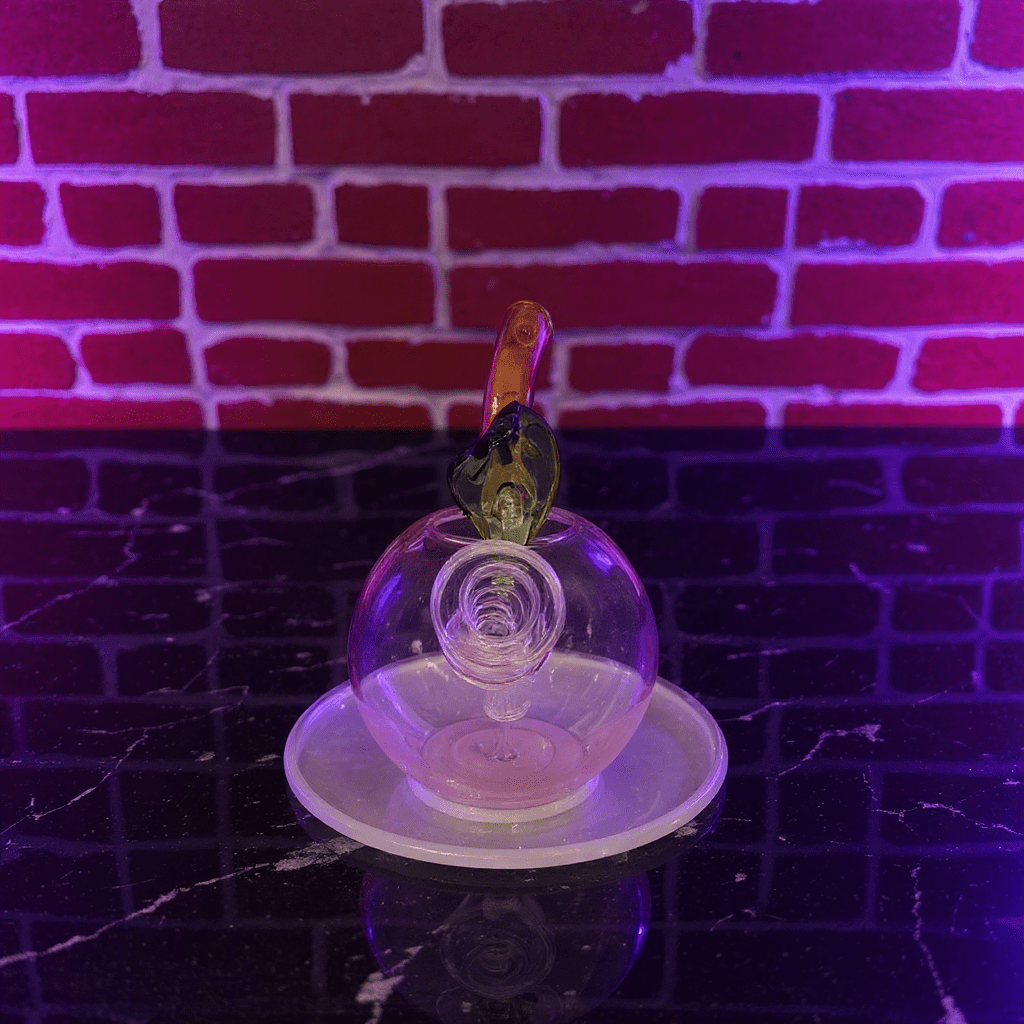 🍎 Apple Glass Bong – Mini Fruit Water PipeGlass bong on a stand with a brick wall background