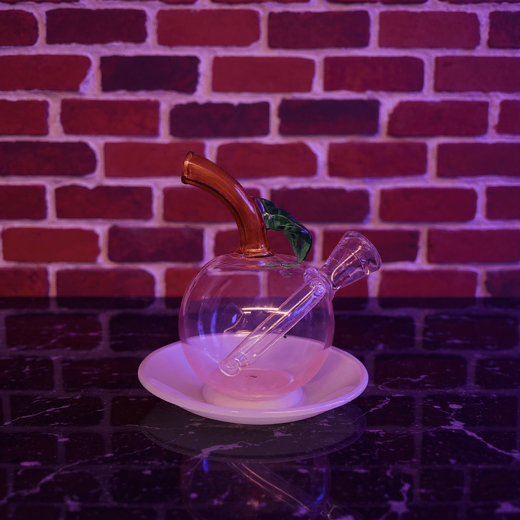 🍎 Apple Glass Bong – Mini Fruit Water PipeGlass apple - shaped pipe with wooden accent on a white plate