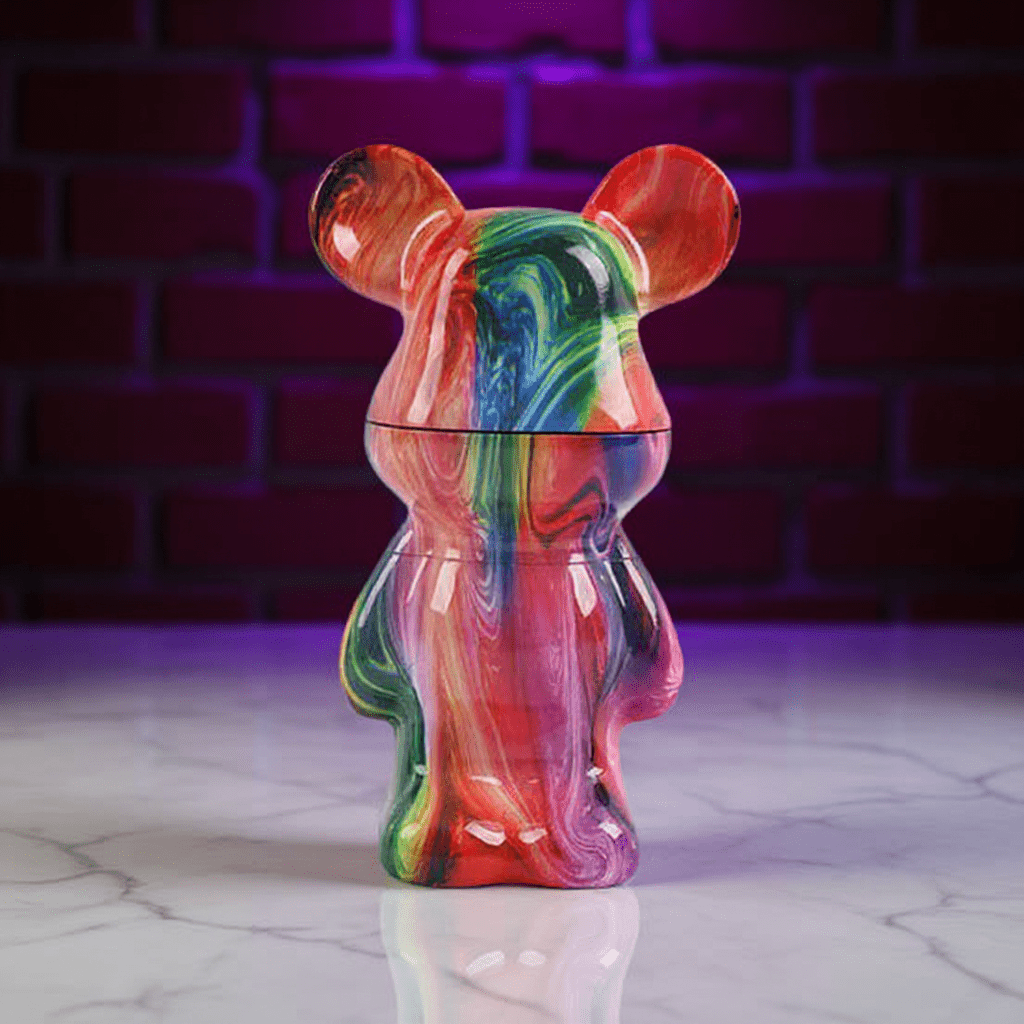 Bear Sculpture Herb GrinderColorful marbled mouse - shaped grinder on a reflective surface with a brick wall background