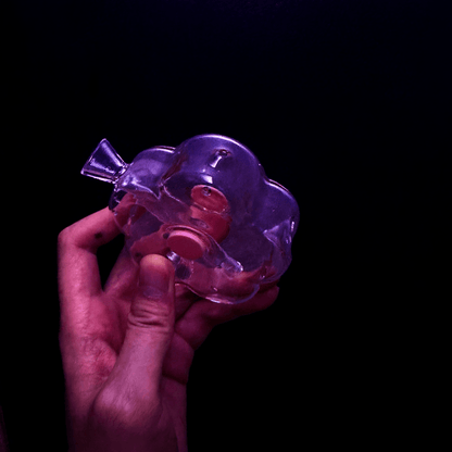 Bloom Puff Glass Bong - Cute bong for girlsHand holding a clear flower glass bong with a dark background