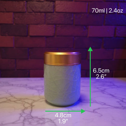 Celadon Porcelain Stash Jar – Light Green Ceramic Herb Storage Containerlight green stash jar with gold lid on a marble surface