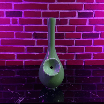 Classic Green Celadon Porcelain Bong with Slim Neck DesignGreen ceramic bong with a unique design against a brick wall background