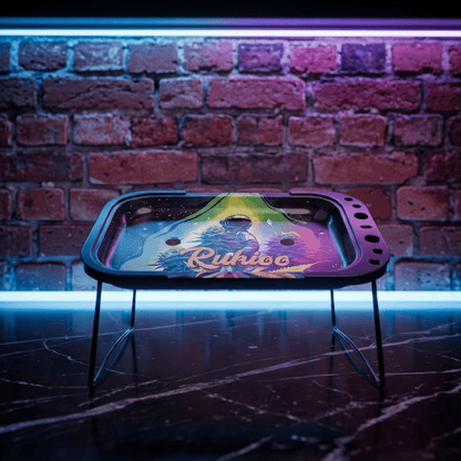 Cosmic Astronaut Elevated Rolling Tray Station – Galaxy Mini Prep TableColorful rolling tray with 'Rukus' branding on a stand against a brick wall.