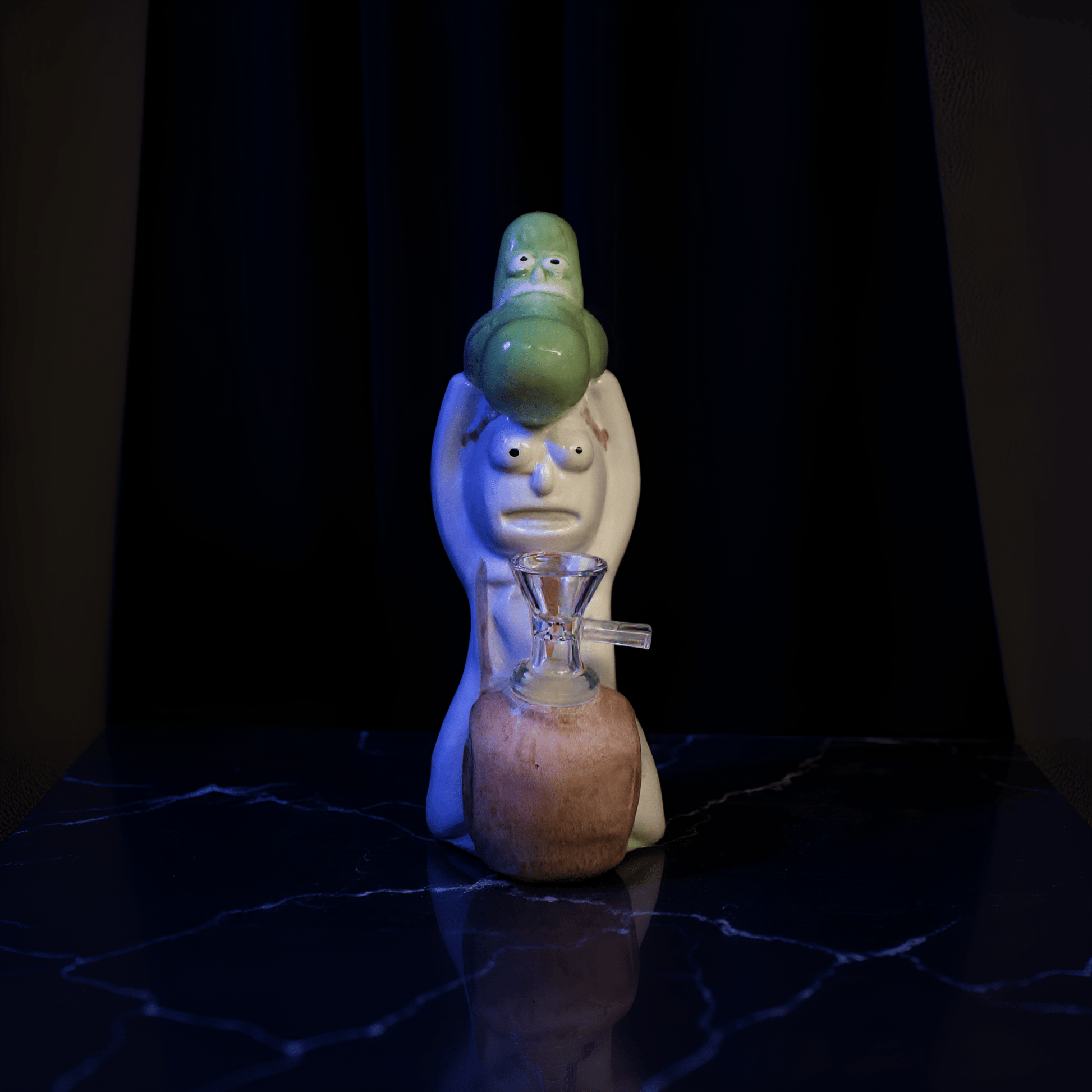 Cosmic Sidekick Ceramic Water Pipe Cartoon pickle ceramic bong on a wooden table in a cozy bedroom.