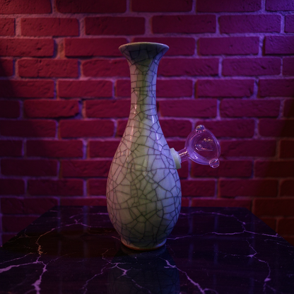 Decorative porcelain bong with cracked glass design on a dark surface