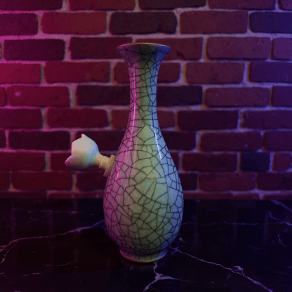 Crackled Light Green Celadon Porcelain Bong – Elegant Ceramic BongDecorative porcelain bong with cracked ceramic design against a brick wall background