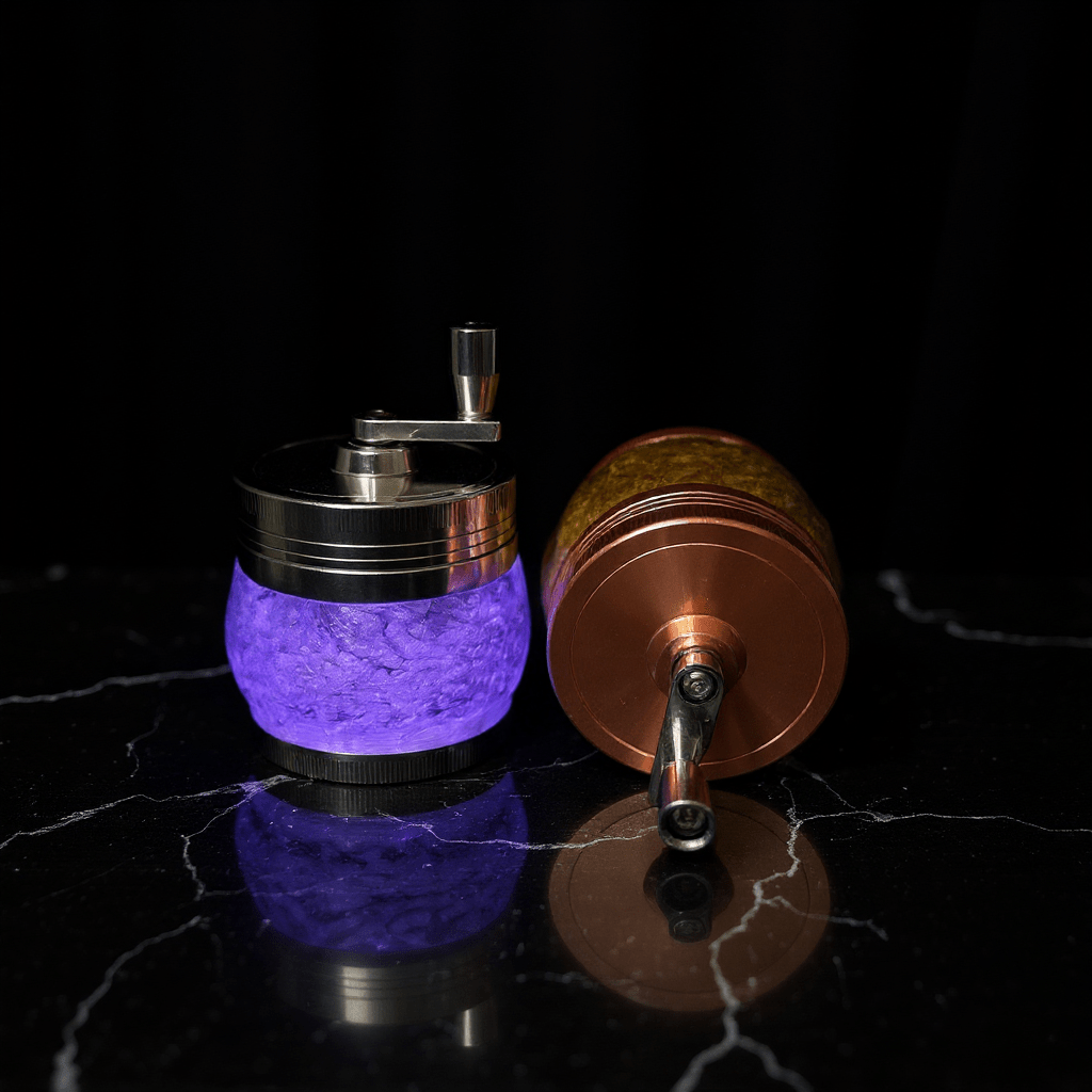 Crystal Hand Crank Herb Grinder - Two tabletop grinders, one purple and one amber, with visible crank handles.