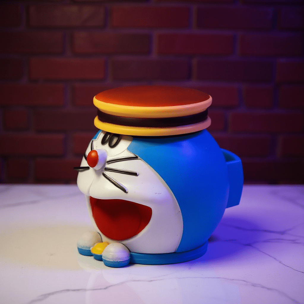 Cute Cat Crank Grinderside view of a blue Doraemon weed grinder with visible storage cap and wide smile