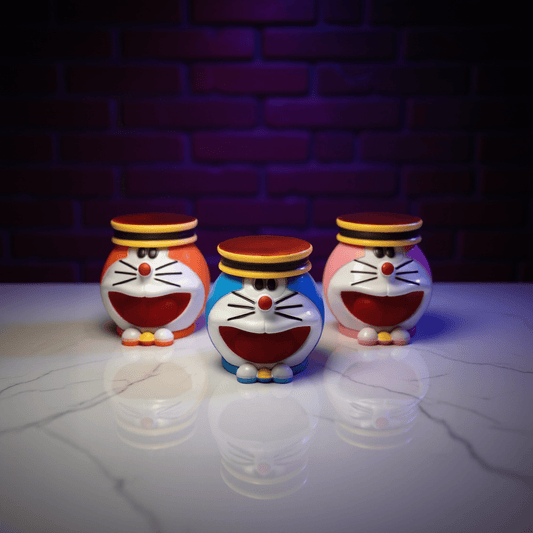 Cute Cat Crank GrinderCute Cat Crank GrinderSet of three Doraemon - weed grinders in orange, blue, and pink on a wooden surface