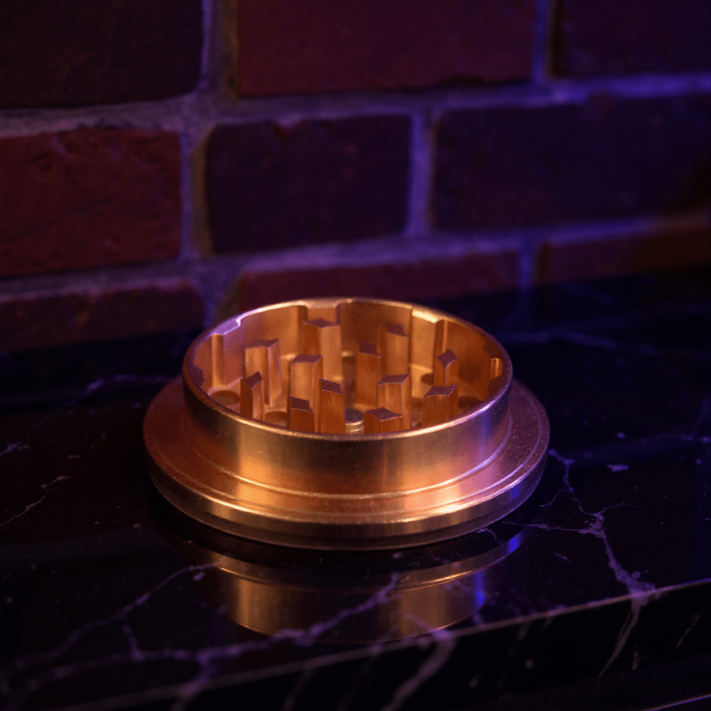 Cute Ceramic Dog Herb GrinderBronze - colored metal grinder on a dark surface with a brick wall background