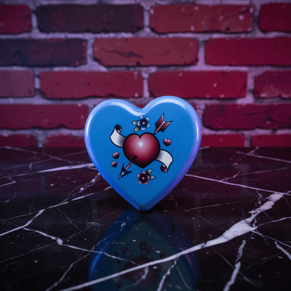 Cute Heart Shaped Herb Grinder – Cupid's Arrow Novelty Spice CrusherHeart - shaped blue with a design on a dark surface and brick wall background