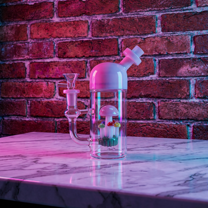 Cute Mushroom Percolator Bong – Mini Fairycore Glass BubblerPink and clear glass smoking bong on a marble surface with a brick wall background